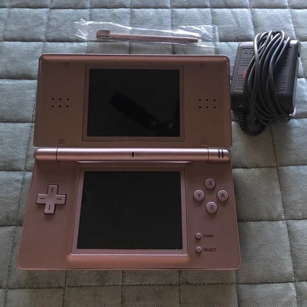 Nintendo DS with charger, games and pink case